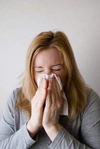 An employee sneezing due to dust allergy