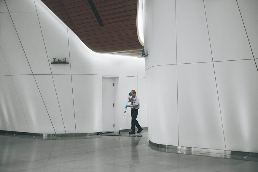 A janitor cleaning an office building