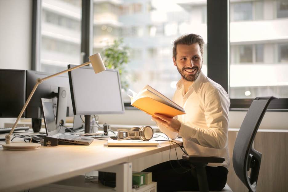 A man working sitting in front of a window