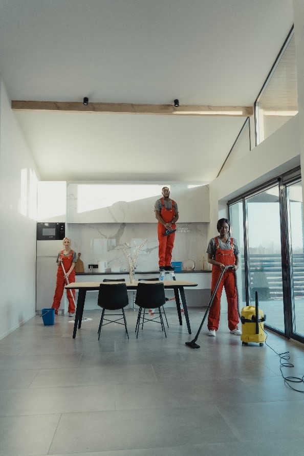 Commercial cleaners working together to clean a kitchen