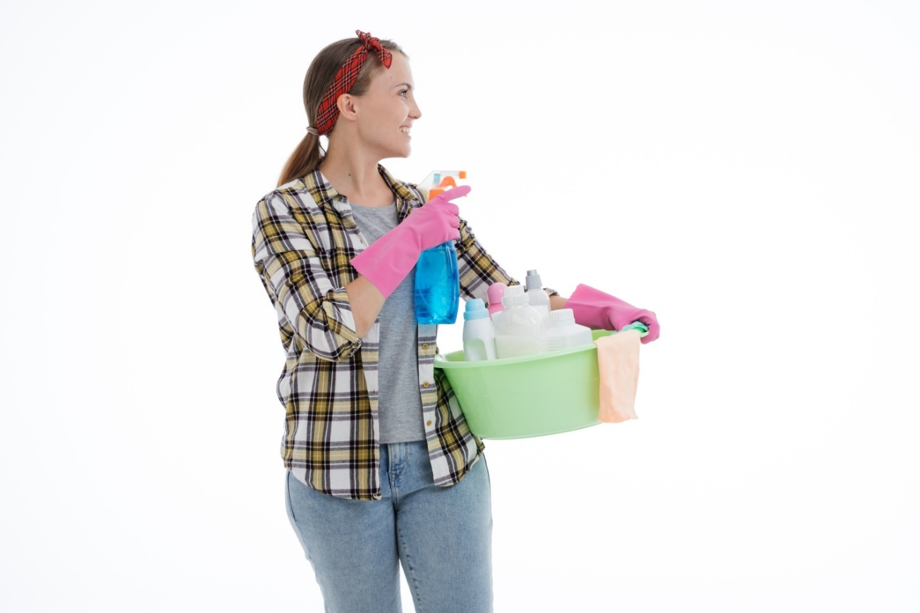  A woman holding cleaning supplies