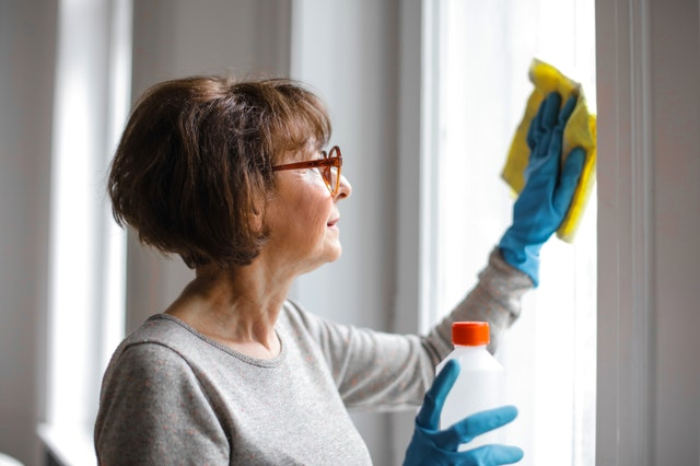 A lady cleaning the window