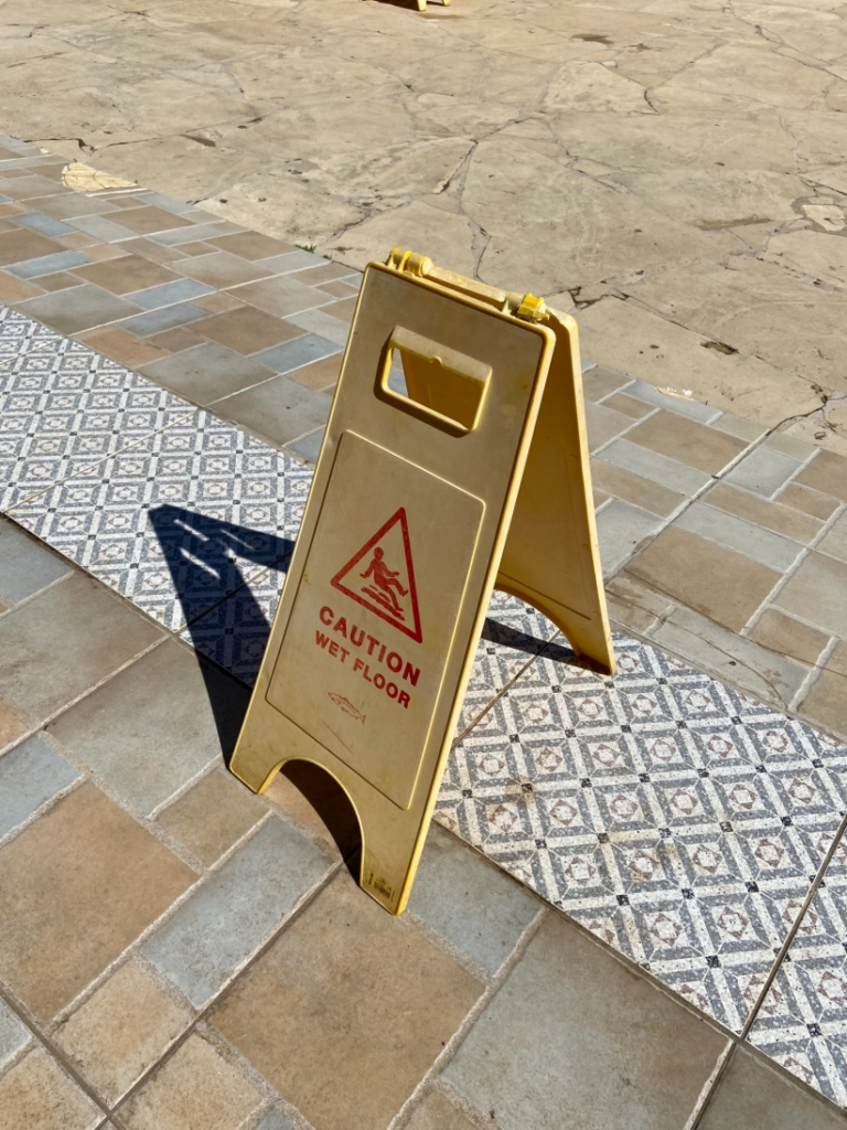 A caution sign indicating wet floor placed during janitorial cleaning services in Kansas City