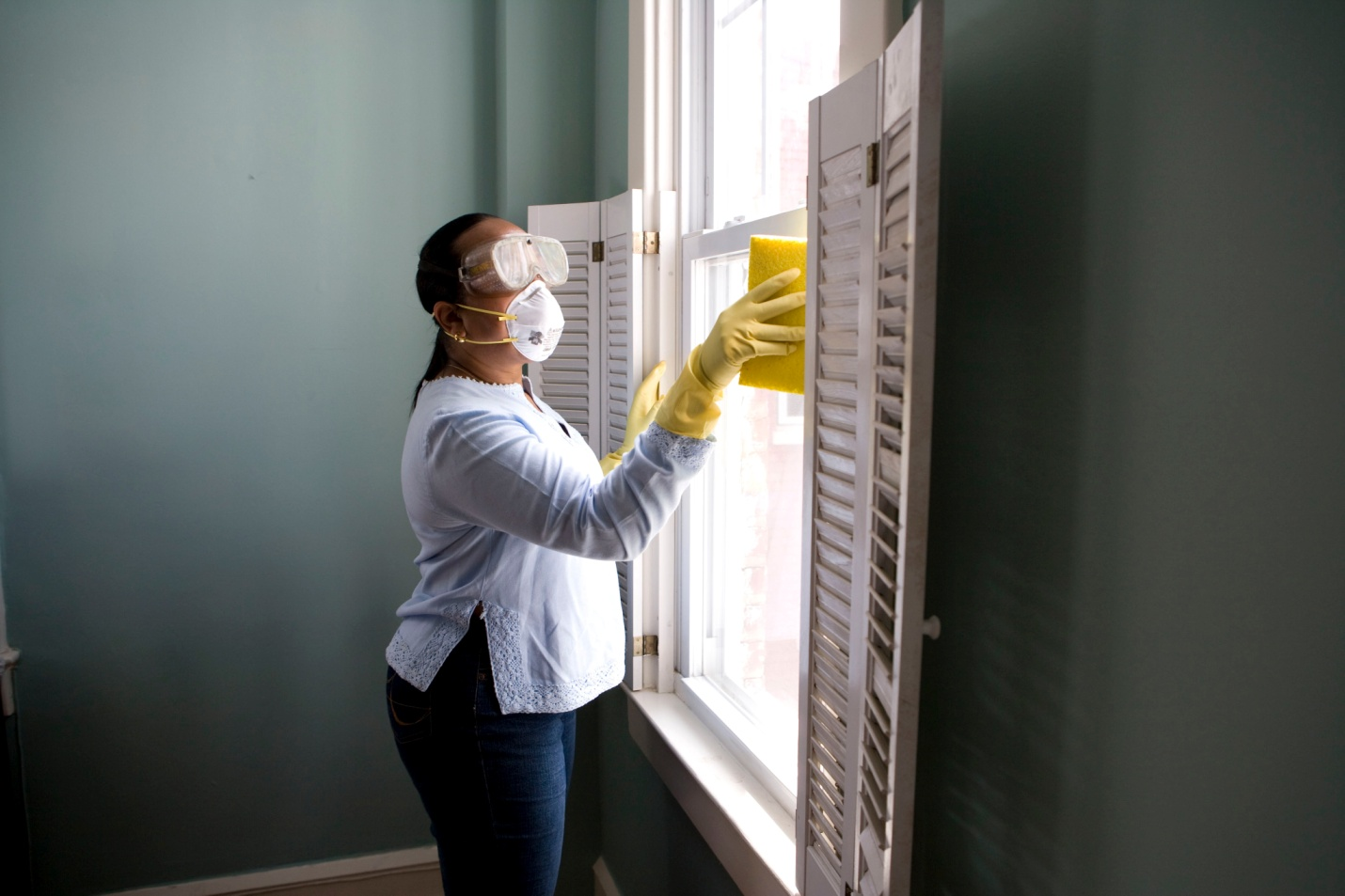a worker disinfecting the window