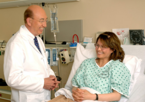 A happy doctor interacting with a patient at a hospital