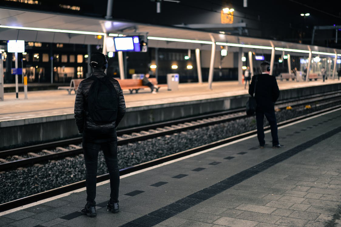 People waiting for a train at a clean railway station
