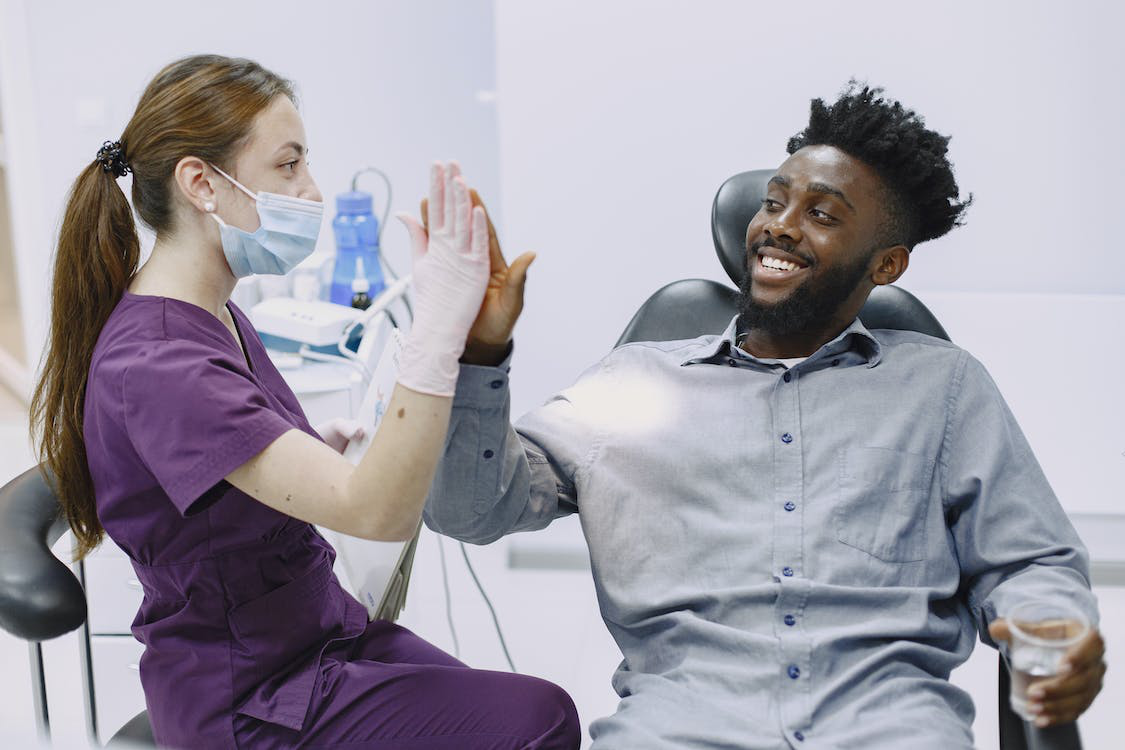 A satisfied medical professional giving a patient a high-five