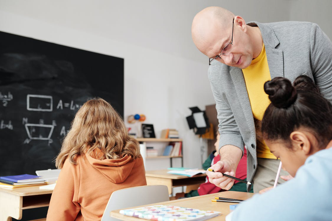 A teacher helping a student