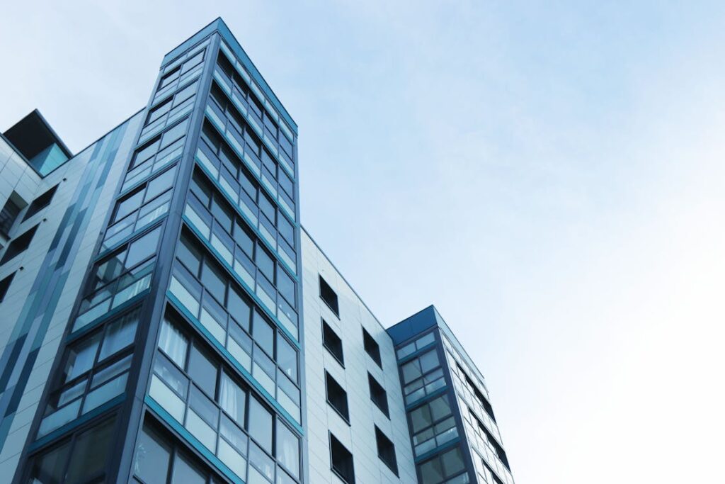 A modern office building against a clear blue sky.