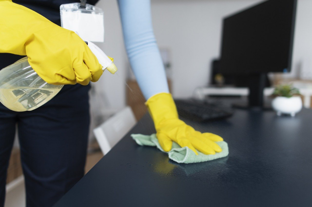 a person cleaning an office desk