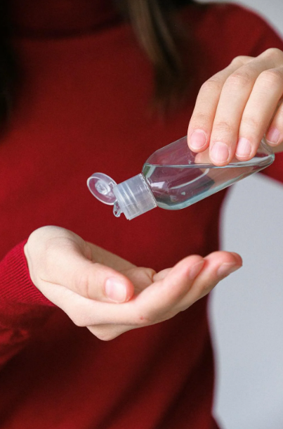 A person sanitizing their hand.