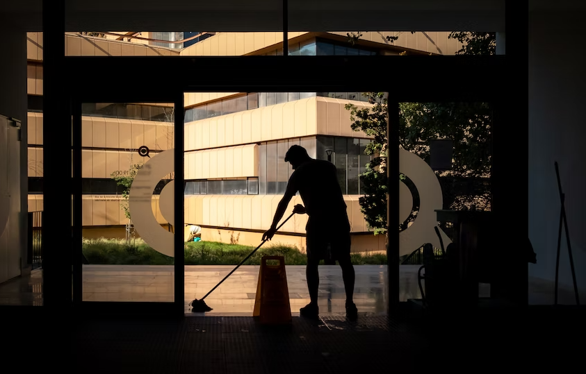 A person cleaning the lobby of a commercial building