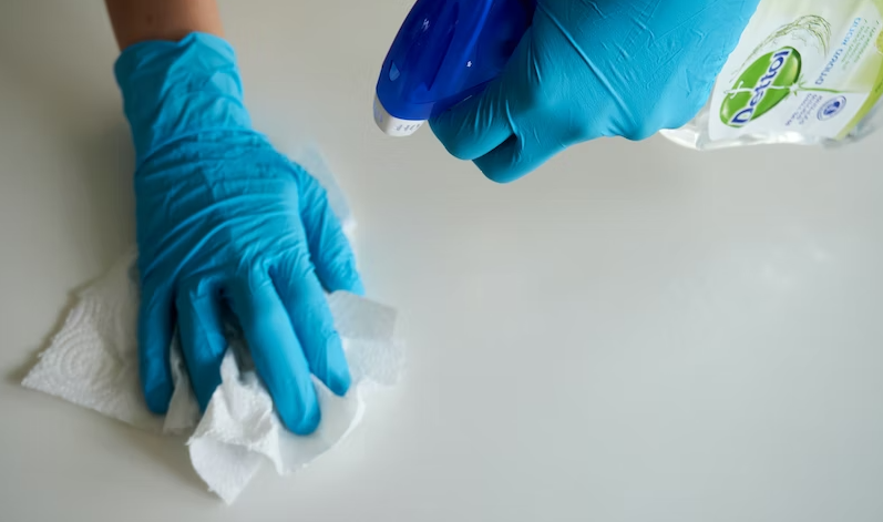 A professional cleaner taking preventive measures for cold and flu season