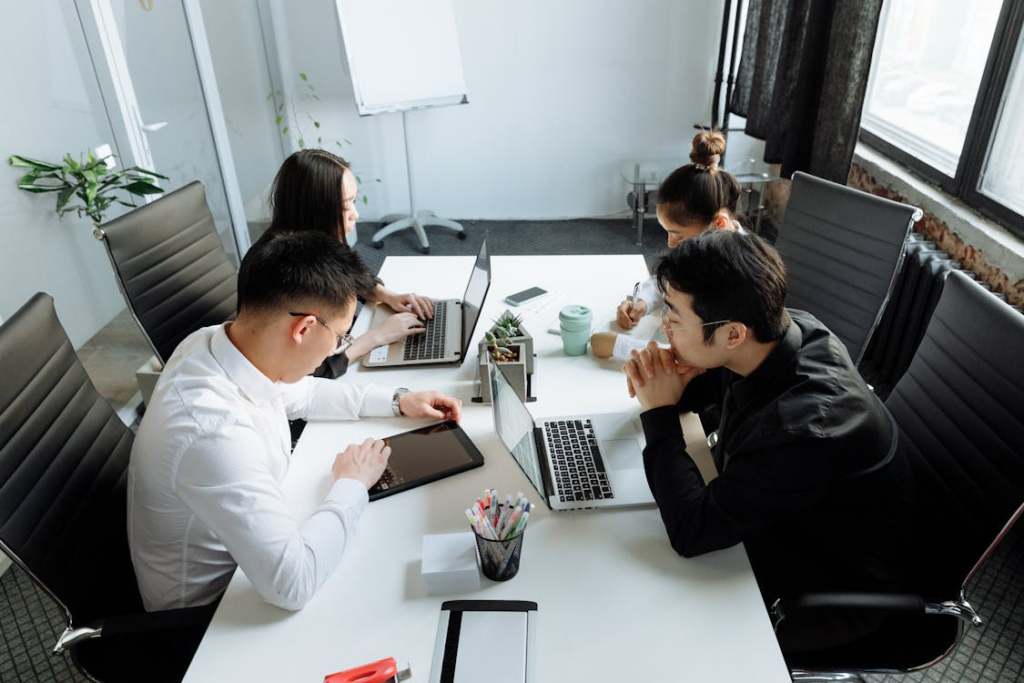 A tidy office with a team of employees working at their desks