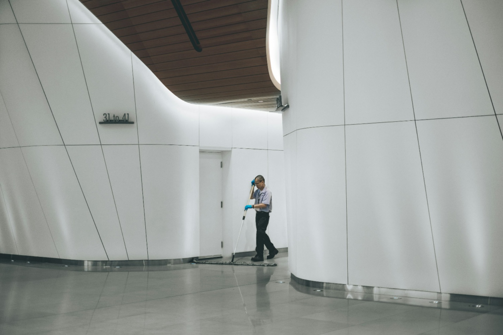 A worker cleaning the floors
