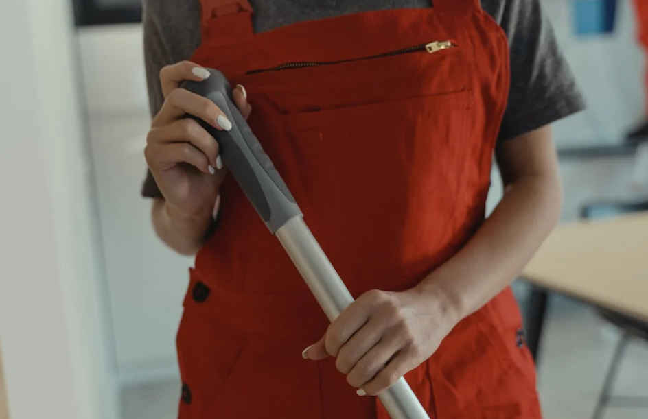 A person holding a cleaning equipment