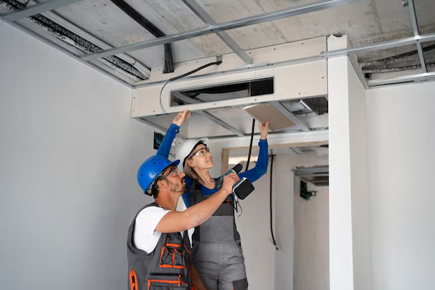 Two people inspecting an HVAC unit