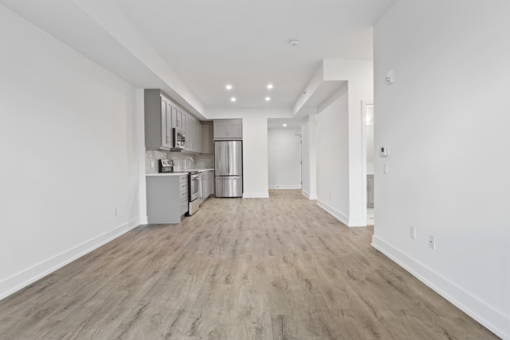 an empty apartment featuring light-colored wood-look flooring