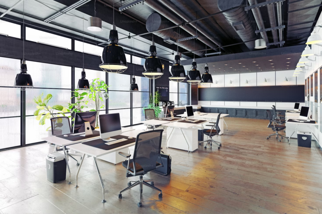 A modern and cozy loft-style office interior with natural lighting, wooden floors, and contemporary furniture.