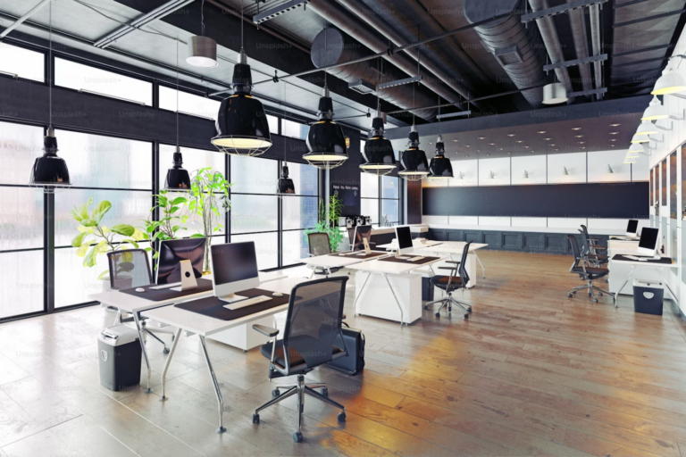 A modern and cozy loft-style office interior with natural lighting, wooden floors, and contemporary furniture.