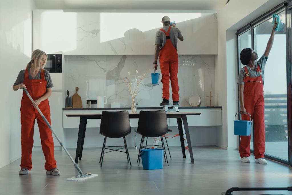 a professional cleaning team hard at work in orange suits