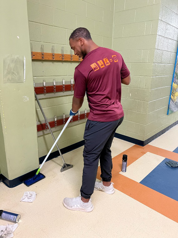Crystal Clear Enterprise professional performing floor cleaning services in a school