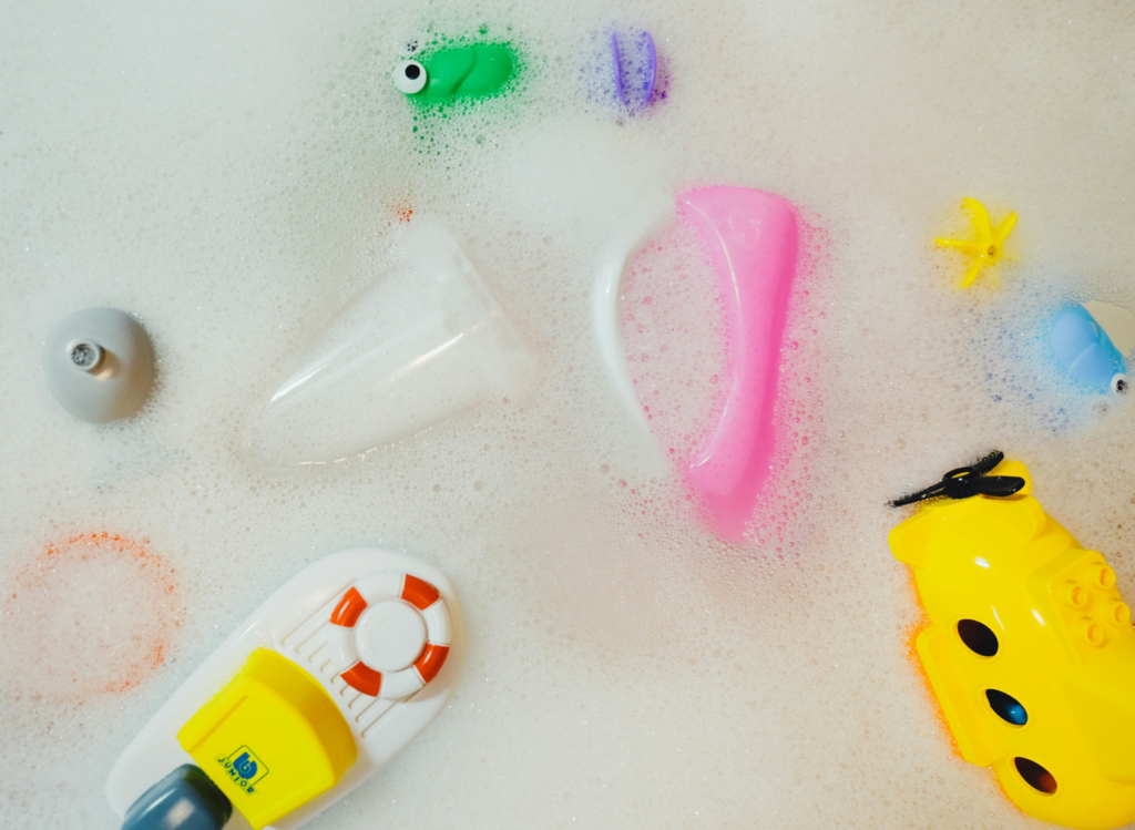 Professional cleaner sanitizing toys and surfaces in a childcare classroom.