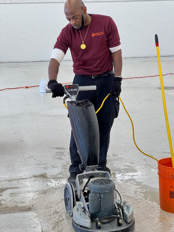 An image of a man cleaning an office floor