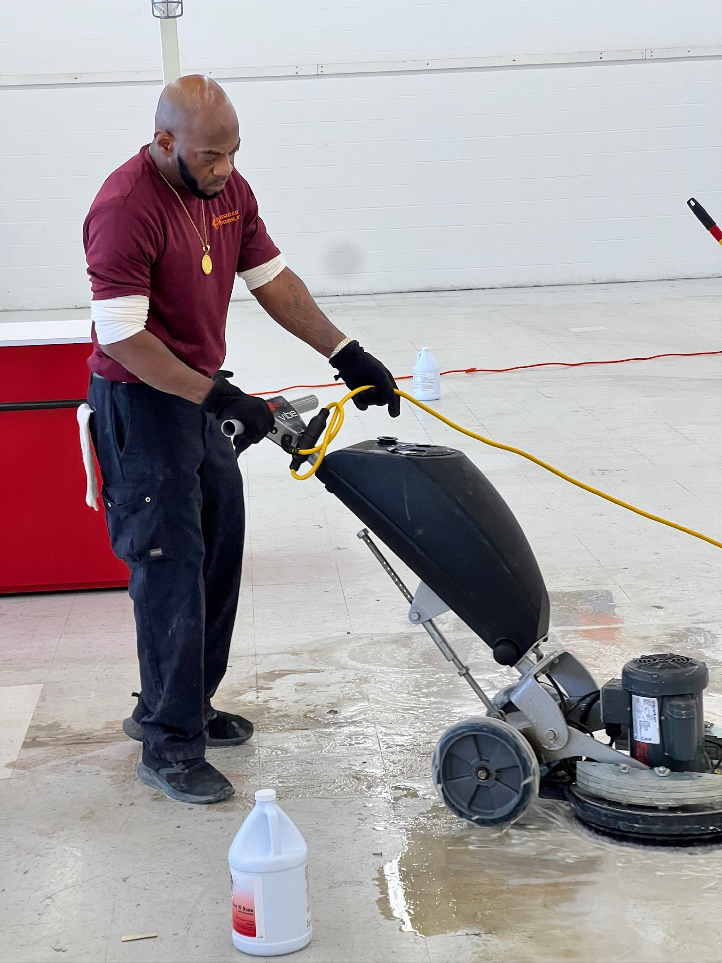An image of a man using high-grade cleaning equipment for floor cleaning