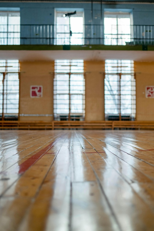 Floor buffing in a school gymnasium.