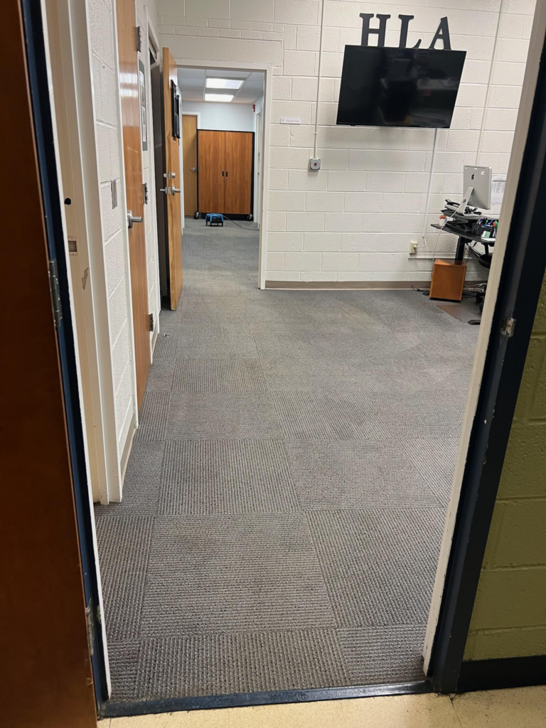 a glance inside a room with a neat carpeted floor