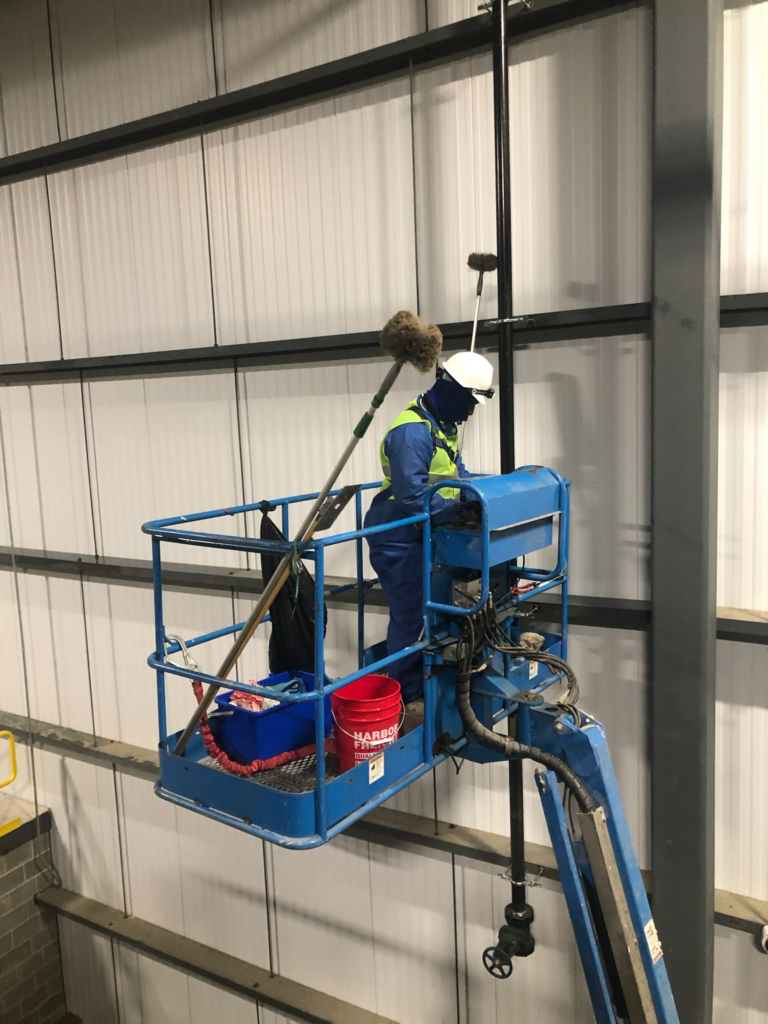 a cleaning service working with cleaning equipment