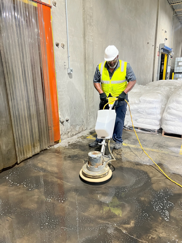 a person removing dirt from the floor using cleaning equipment