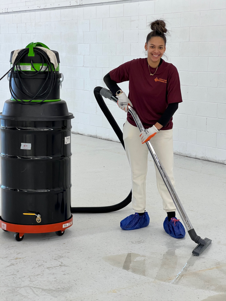 a female worker cleaning a white floor