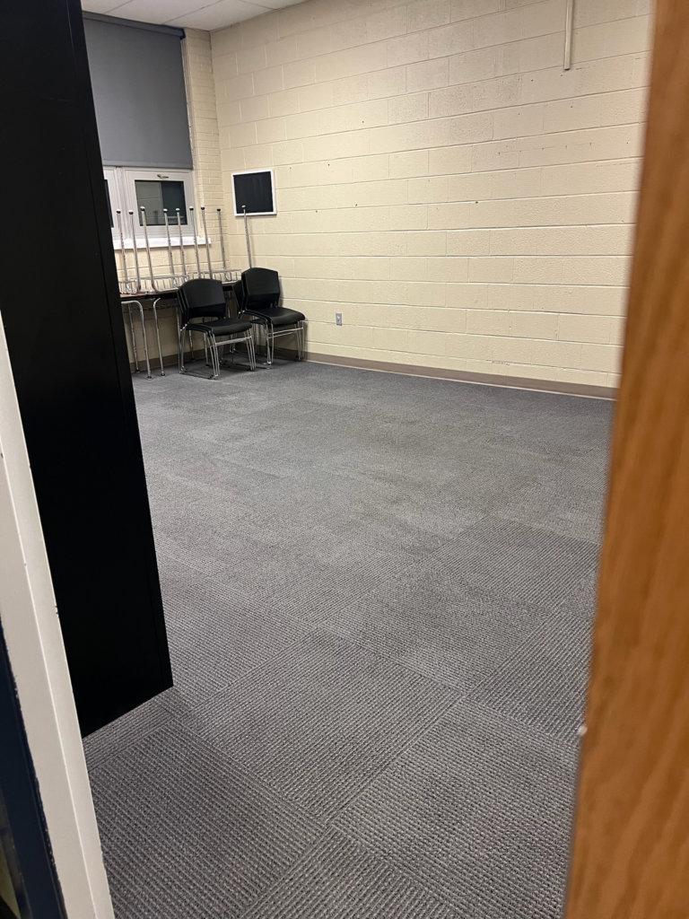 a grey carperted room for meetings