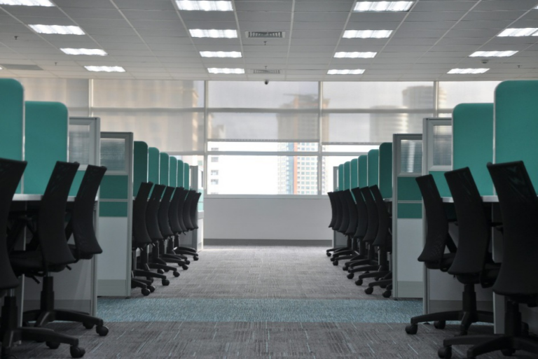 Clean office cubicles with organized desks and chairs in a modern workspace