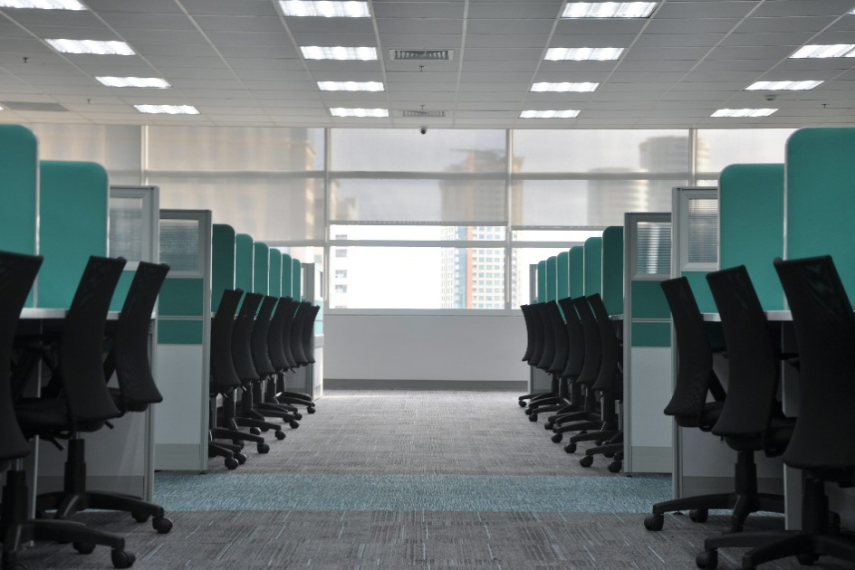 Clean office cubicles with organized desks and chairs in a modern workspace