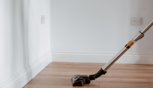Vacuum cleaner on hardwood floor in a clean, minimal interior space